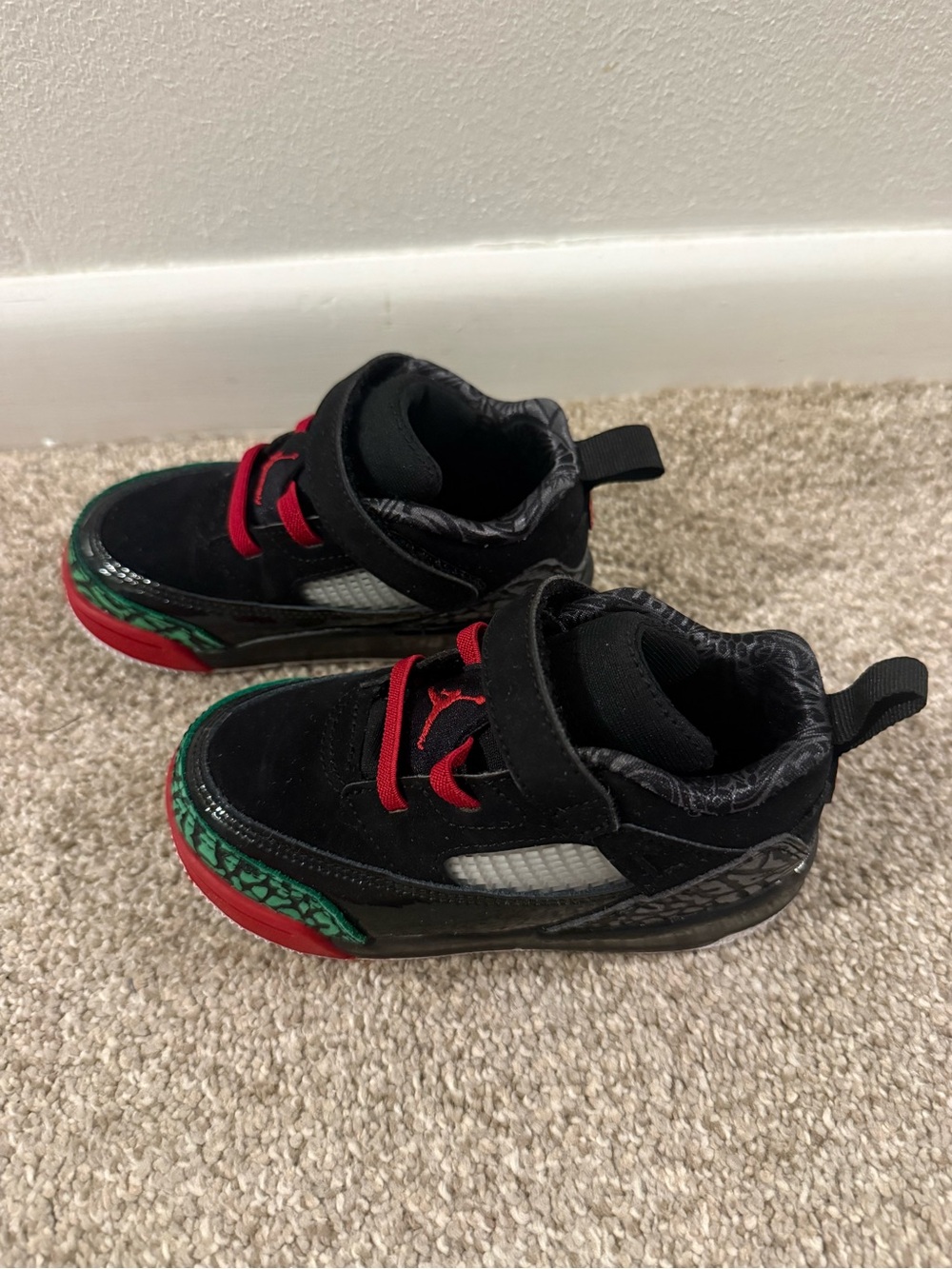 Kids Jordan Black and Red Athletic Sneakers with Green Accent